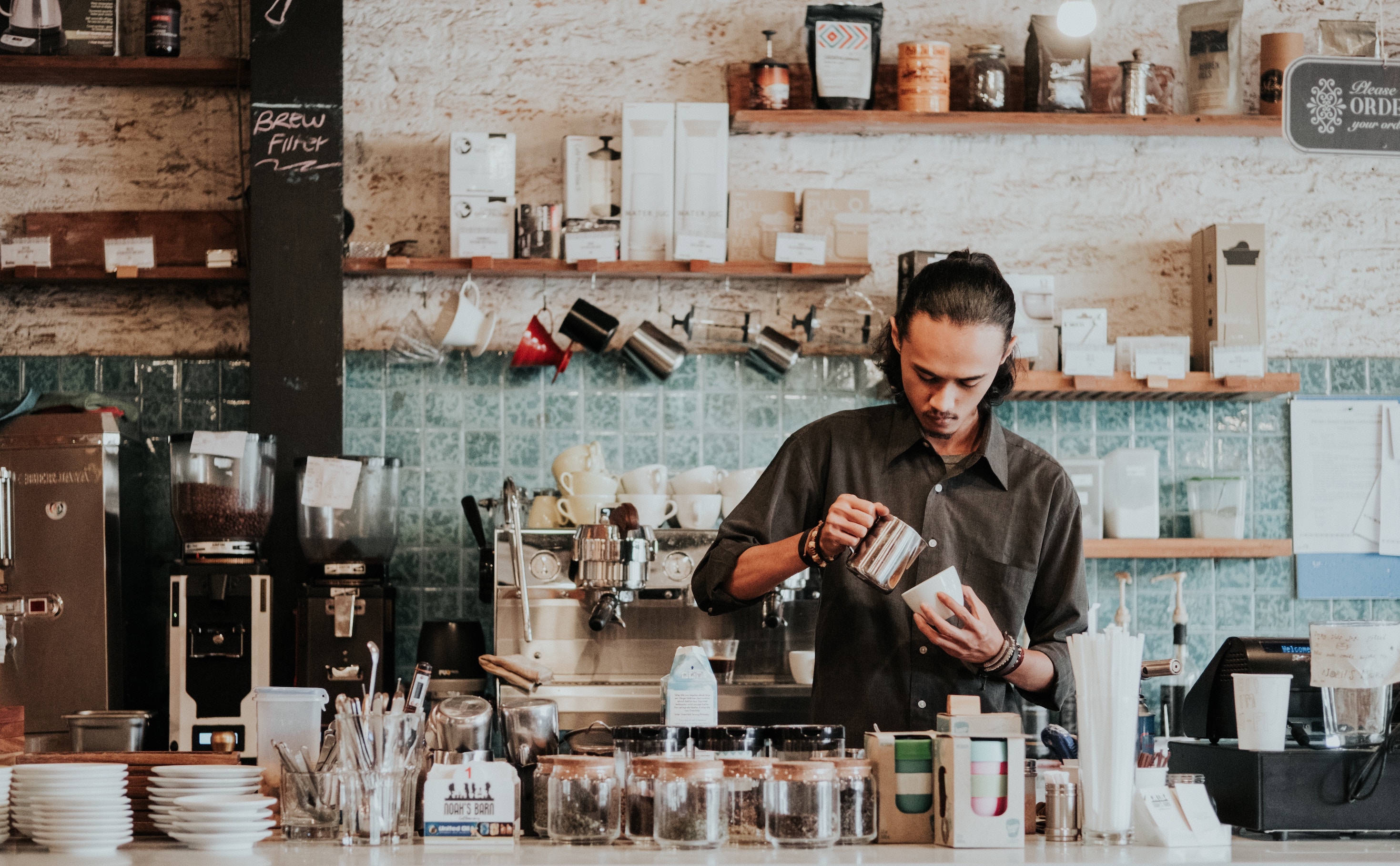 Man in a coffee shop making coffee